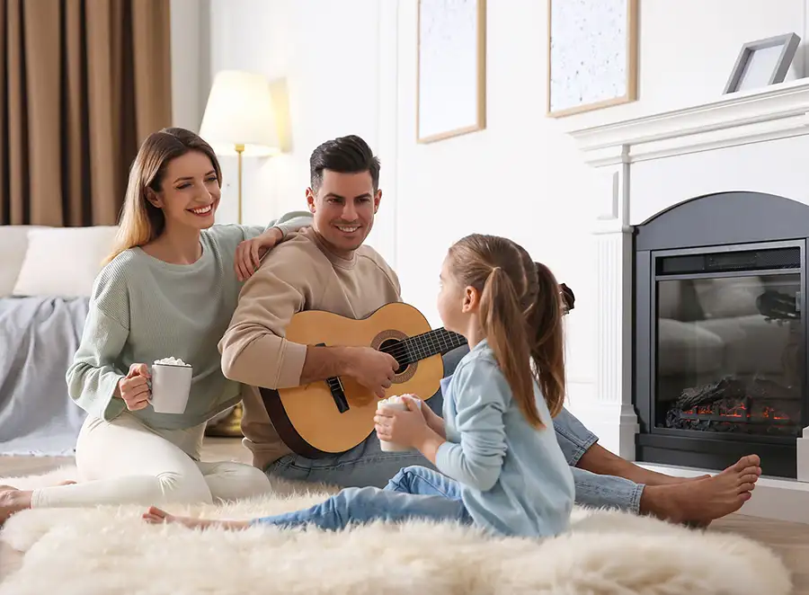 young family enjoying themselves next to a fireplace decatur il